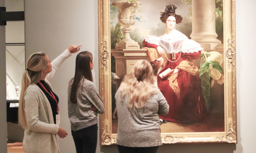 People looking at painting in museum