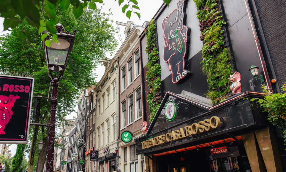 A street in Amsterdam with Bar Rosso. People walking in the background.