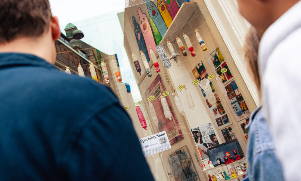 Tourists look through shop window the condomerie in Amsterdam.